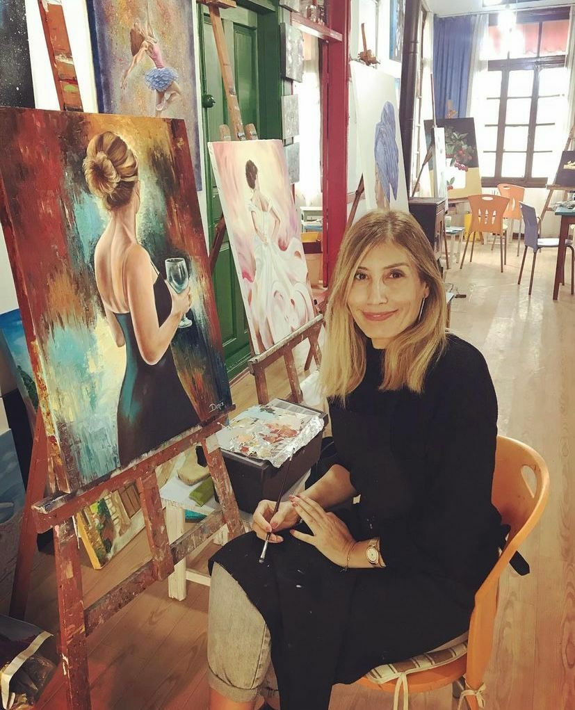 female artist by her painting